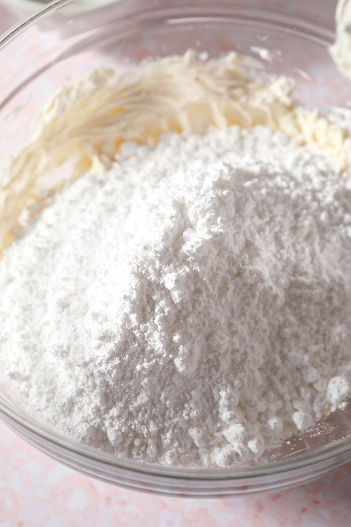 Powdered sugar on top of a cream cheese mixture before blending for an icing