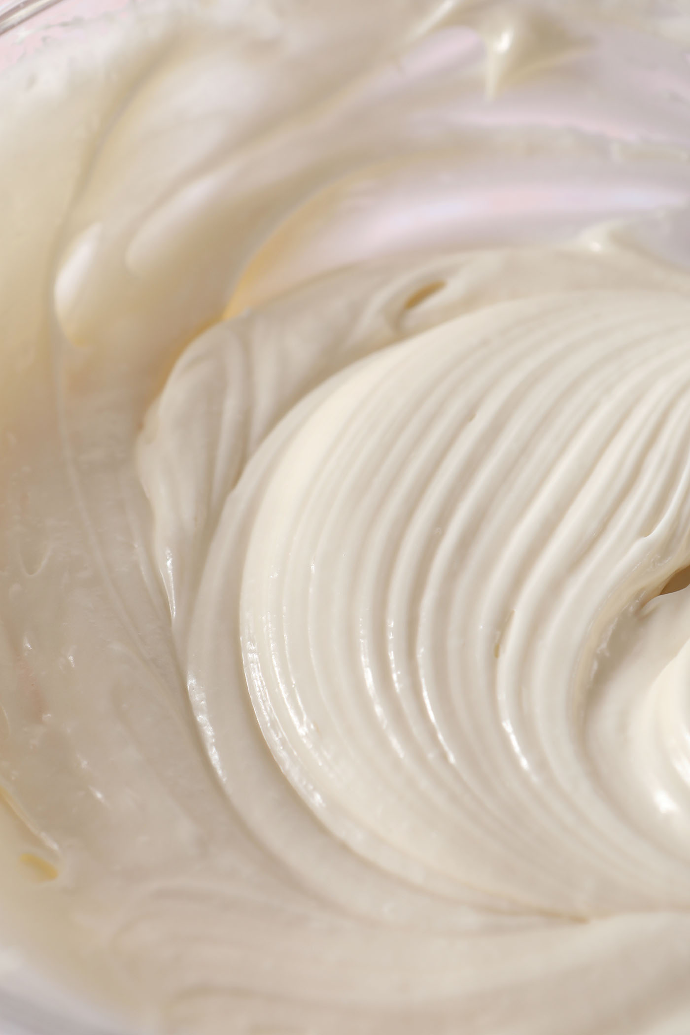 Creamy cream cheese icing in a bowl after blending