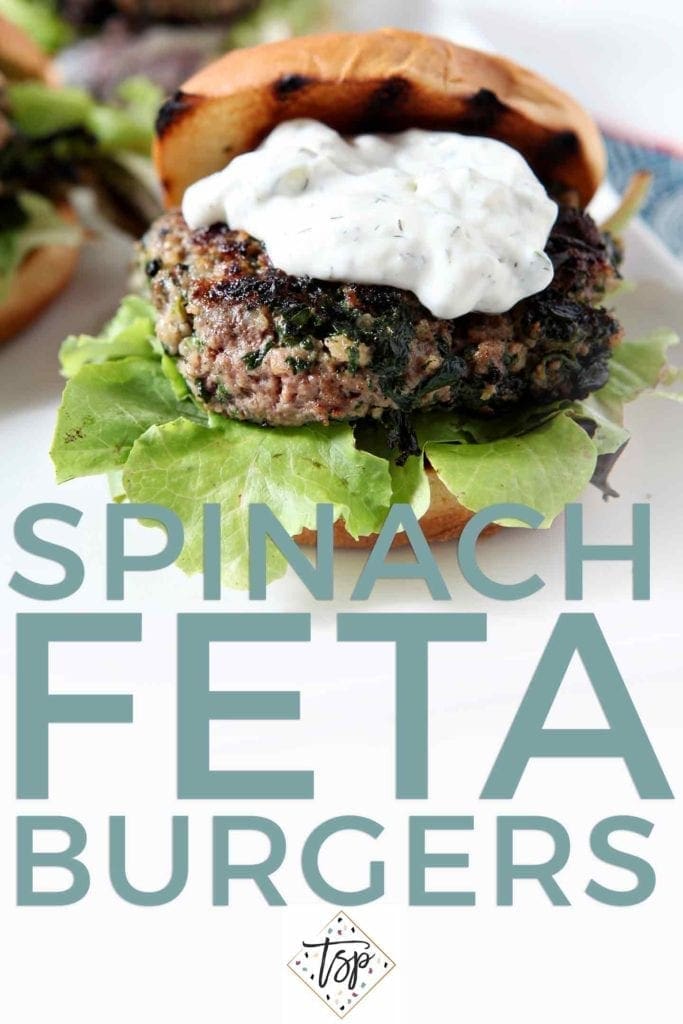 Pinterest graphic for Spinach and Feta Burger, featuring text and a close up of a burger, topped with tzatziki sauce