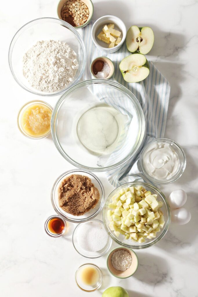 Muffin ingredients in bowls on marble