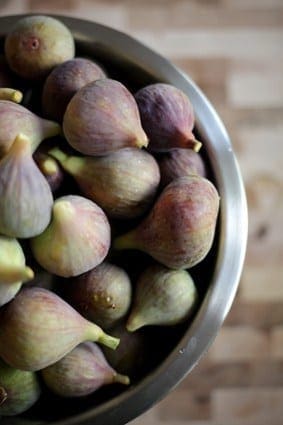 Close up view of whole figs in a metal bowl 