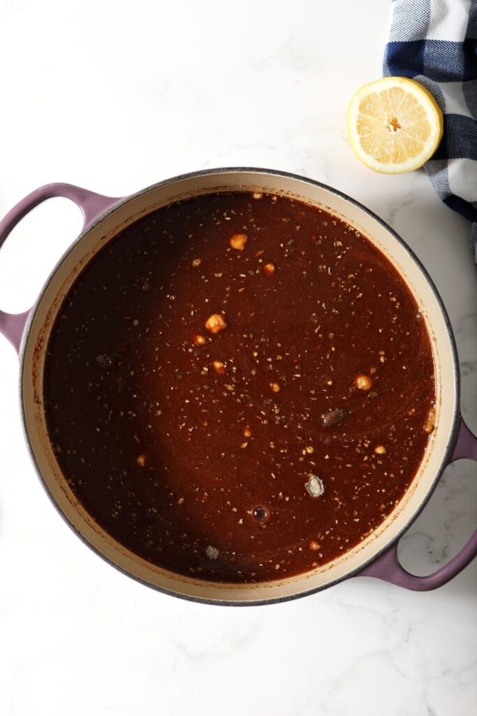 Ingredients mixed into liquid in a Dutch oven