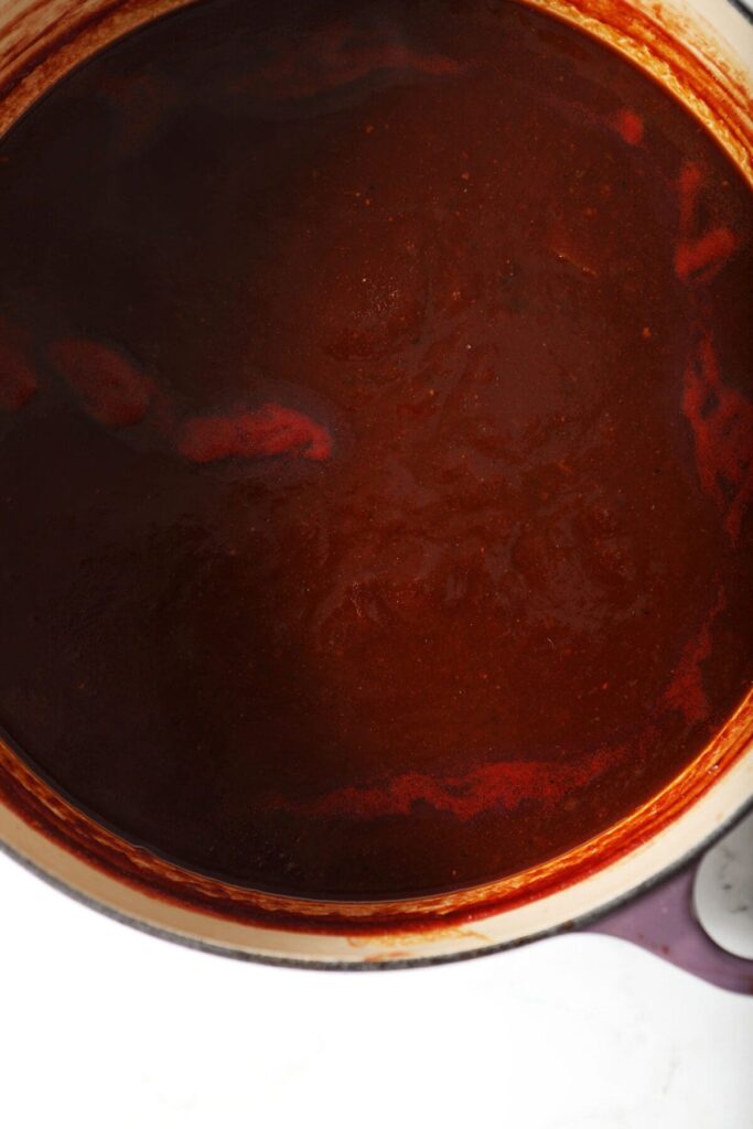 Close up of boiled down barbecue sauce in a large dutch oven