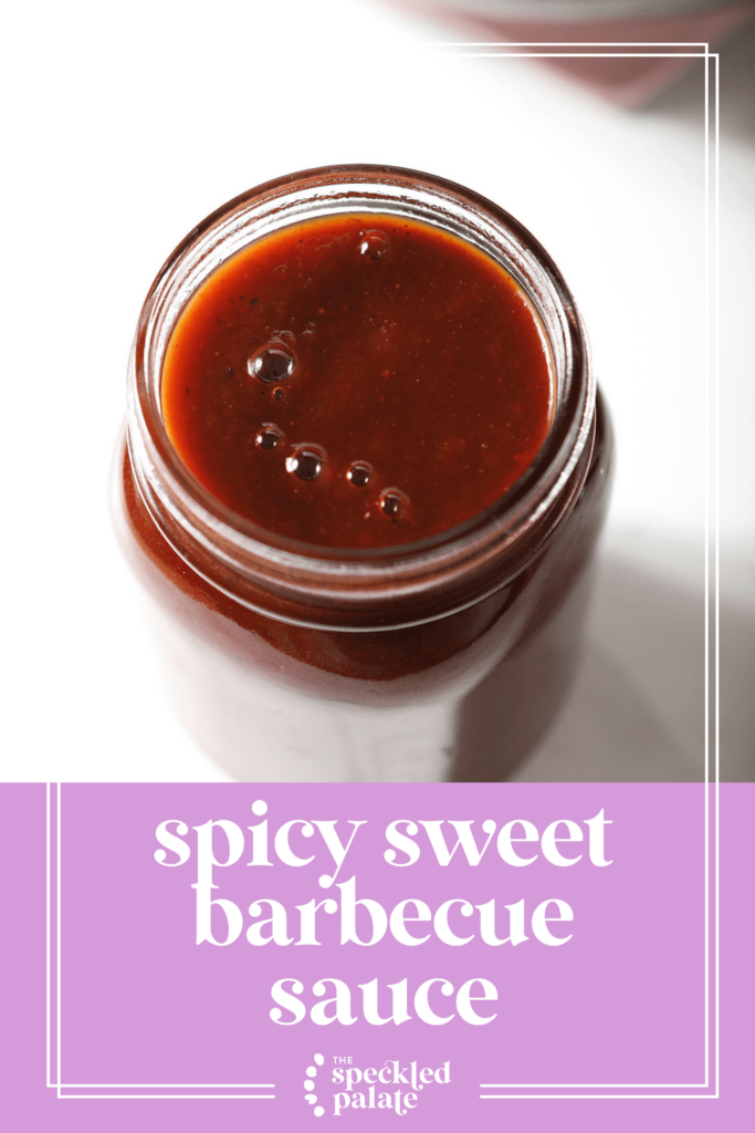 A reddish sauce in a jar with bubbles on top with the text Spicy Sweet Barbecue Sauce