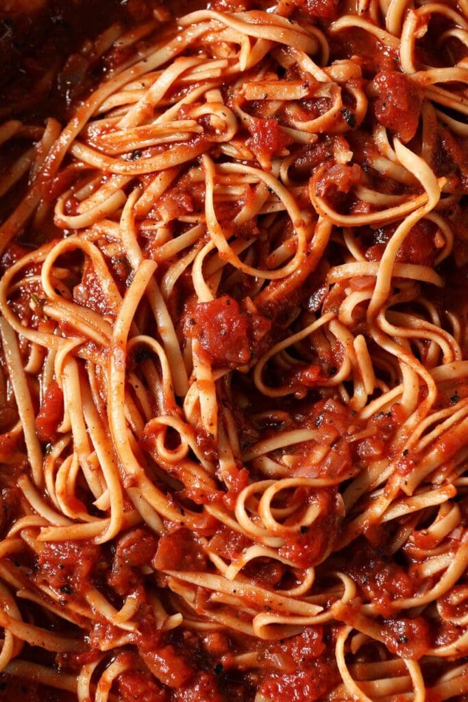 Close up of pasta noodles in simple homemade marinara sauce