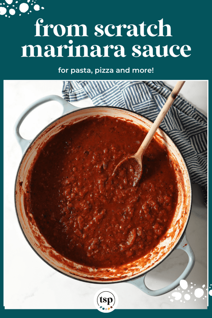 A pot of easy marinara sauce after simmering next to a blue checked towel with a wooden spoon with the text from scratch marinara sauce for pasta, pizza and more