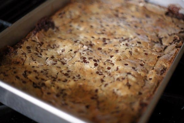 Golden brown cheesecake brownies in a pan