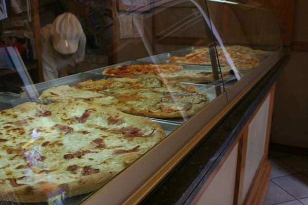 Pizzas behind glass in Cortona, Italy