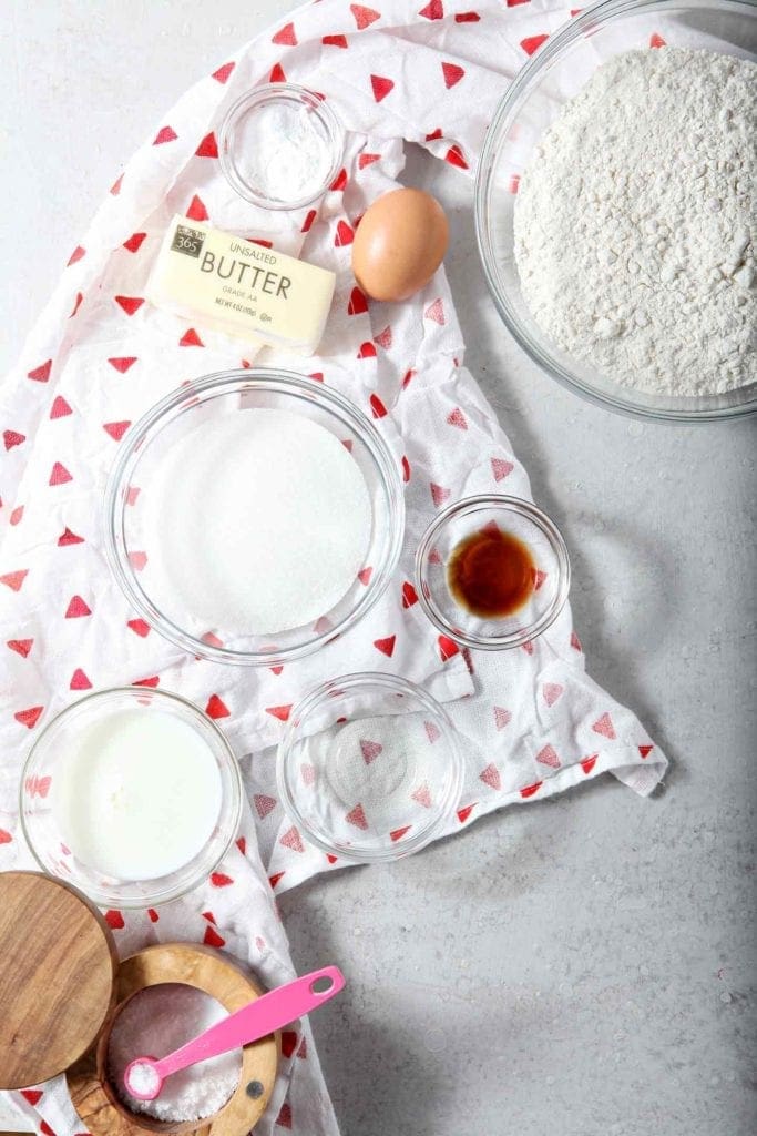 Ingredients for All-Butter Tea Cake Cookies are laid out on a grey backdrop, ready for mixing