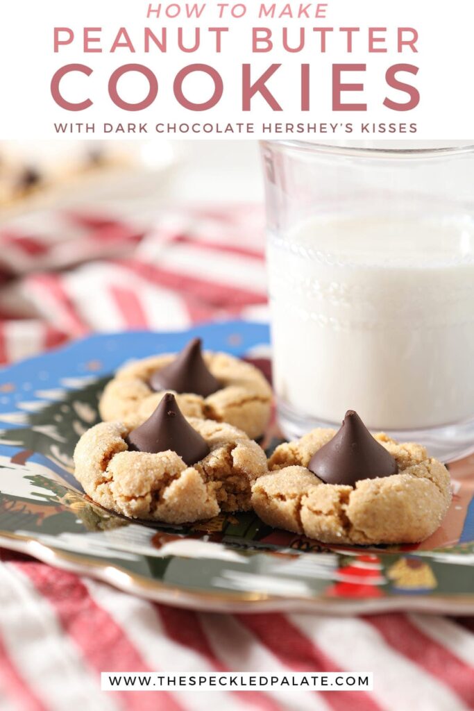 Three Dark Chocolate Peanut Blossoms sit on a blue painted plate next to a glass of milk on top of a red and white striped towel with the text 'how to make peanut butter cookies with dark chocolate hershey's kisses'