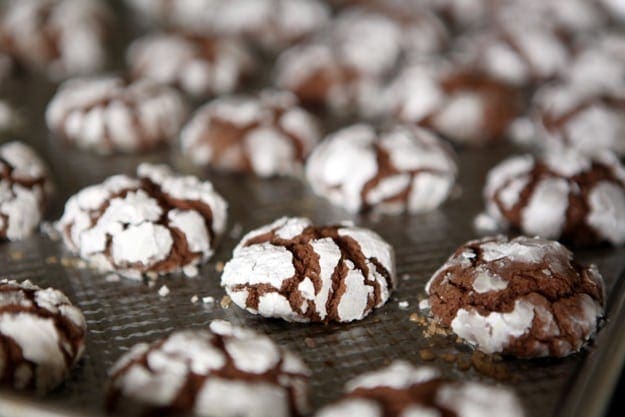 Chocolate crinkle cookies on a baking sheet