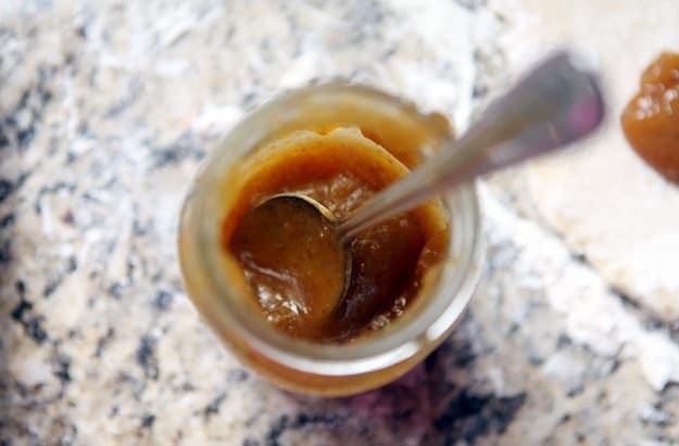 A jar of fig preserves from above with a spoon inside it