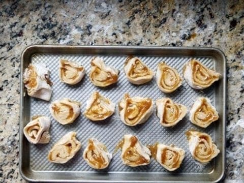Sliced Fig Pinwheels on a metal baking pan before baking
