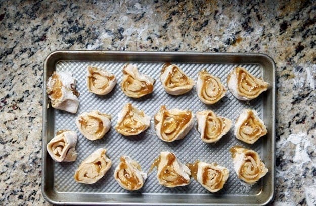 Sliced Fig Pinwheels on a metal baking pan before baking