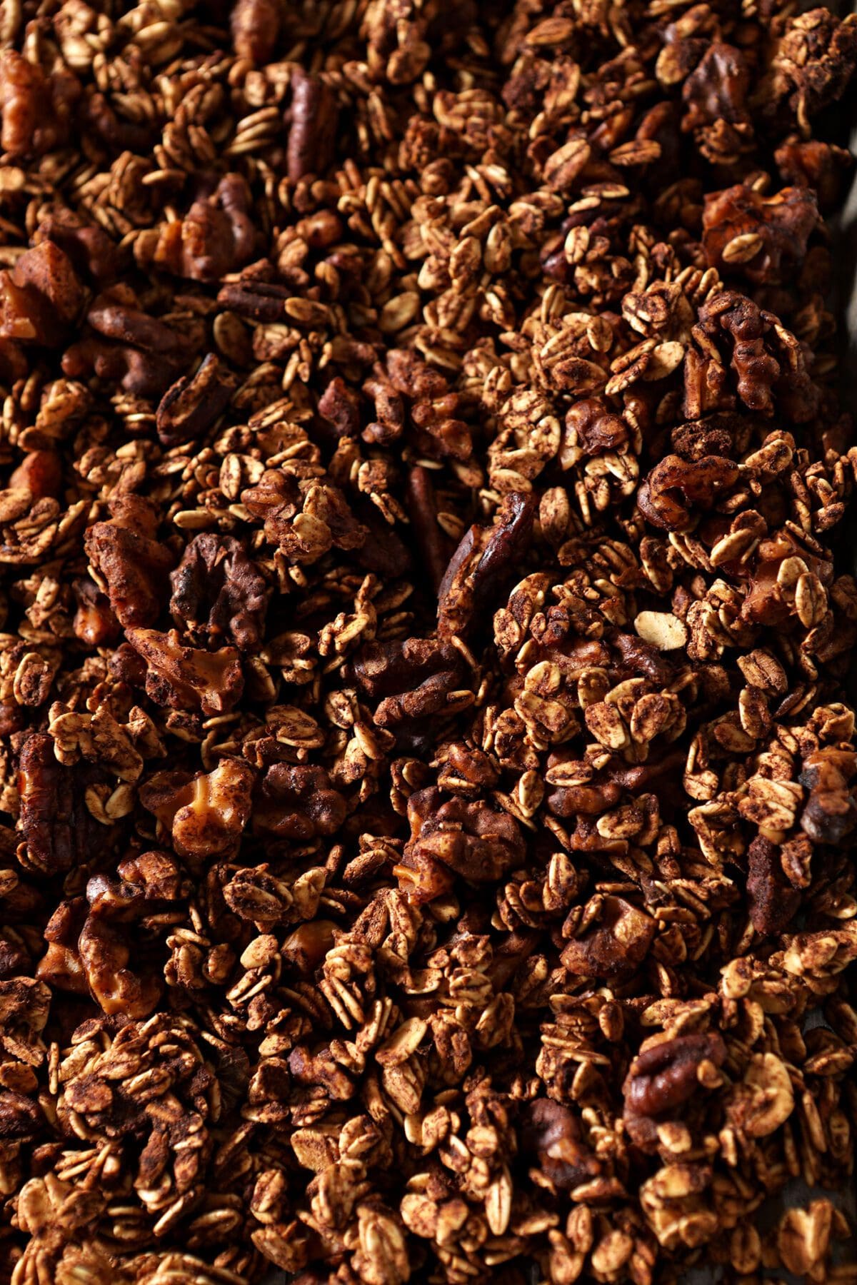 Baked granola on a sheet pan before cranberries are added