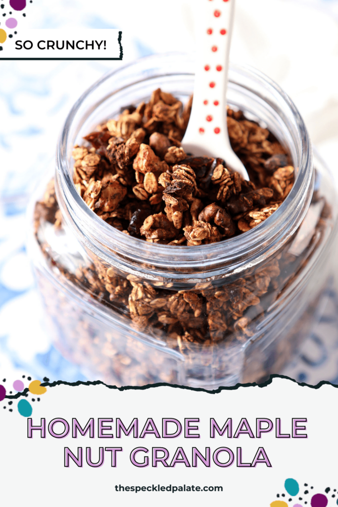 A jar of homemade granola with a spoon in it on a blue tile surface with the text homemade maple nut granola