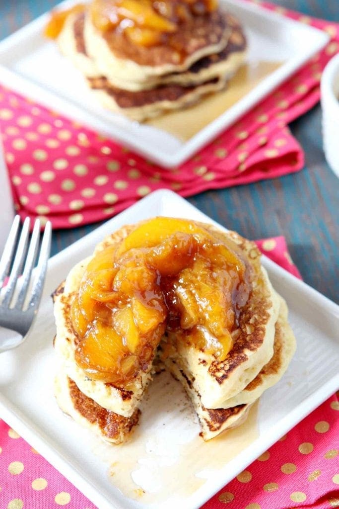 Close up of peach compote on a stack of pancakes, cut into