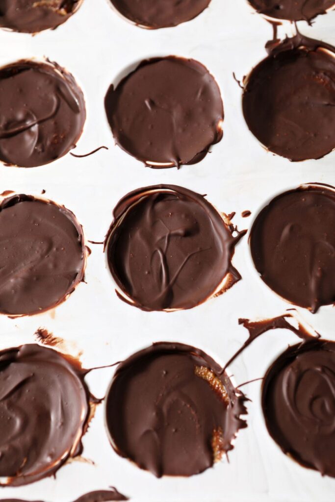 Miniature peanut butter cups in a muffin tin after chilling