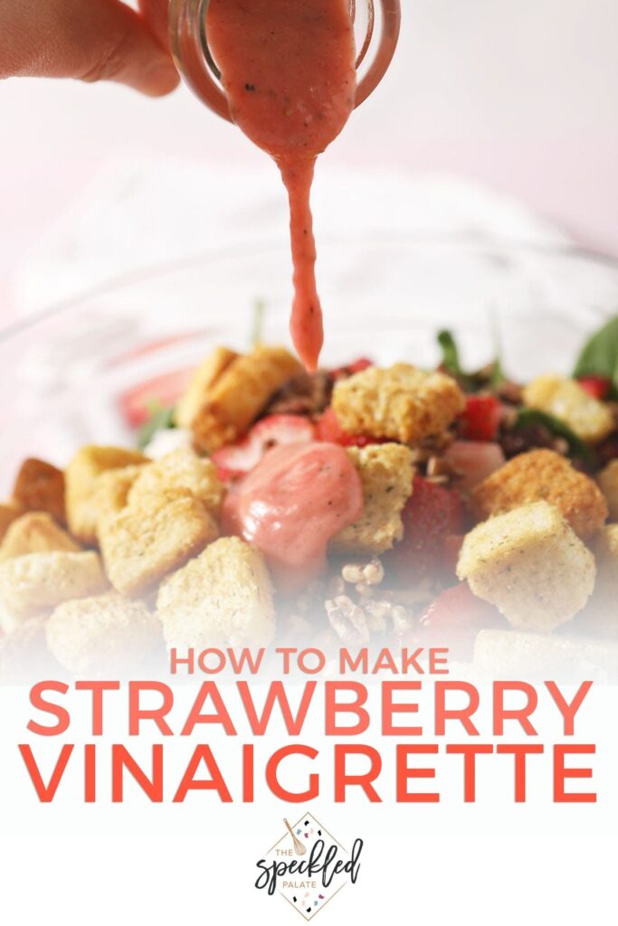 Strawberry salad dressing drizzles on top of a salad with croutons, cheese and more with the text 'how to make strawberry vinaigrette'