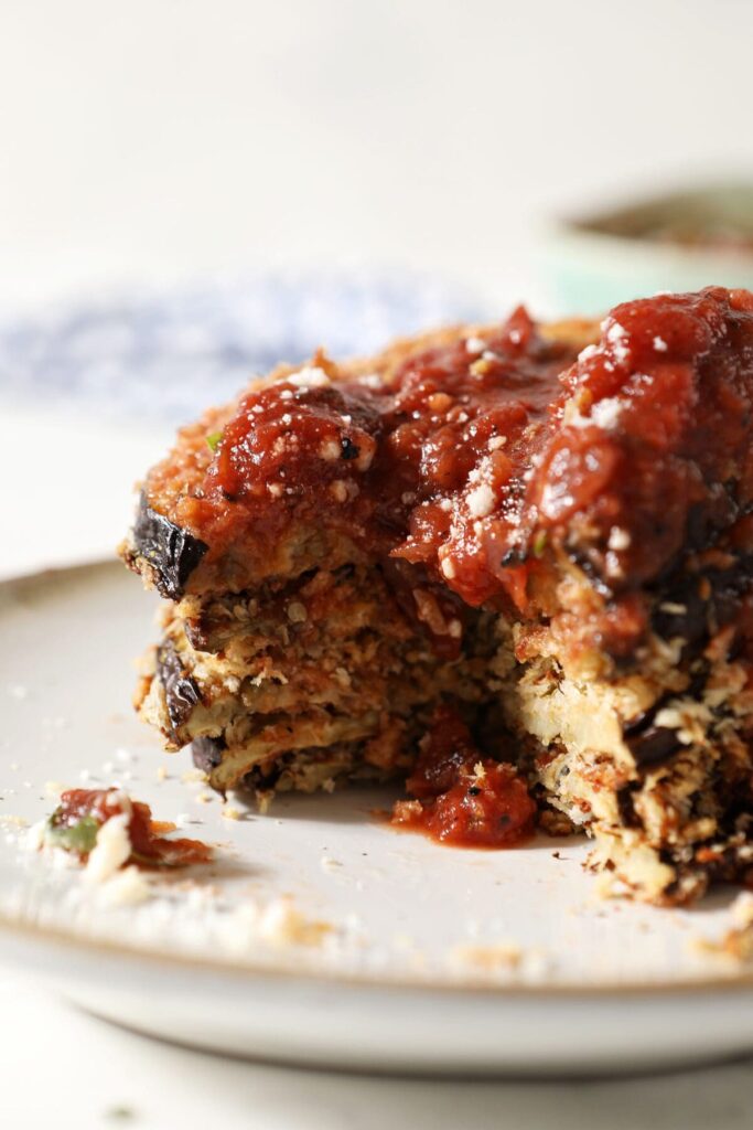 A stack of sliced crispy eggplant medallions on a plate