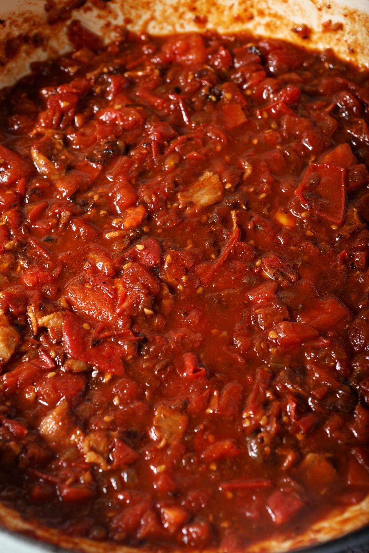 Cooked down tomatoes and other sauce ingredients in a skillet