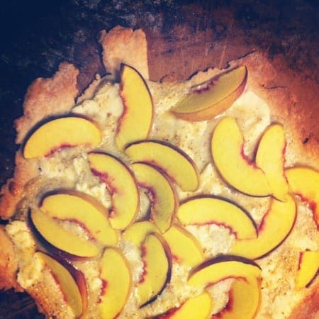 Overhead view of slice peaches on dough