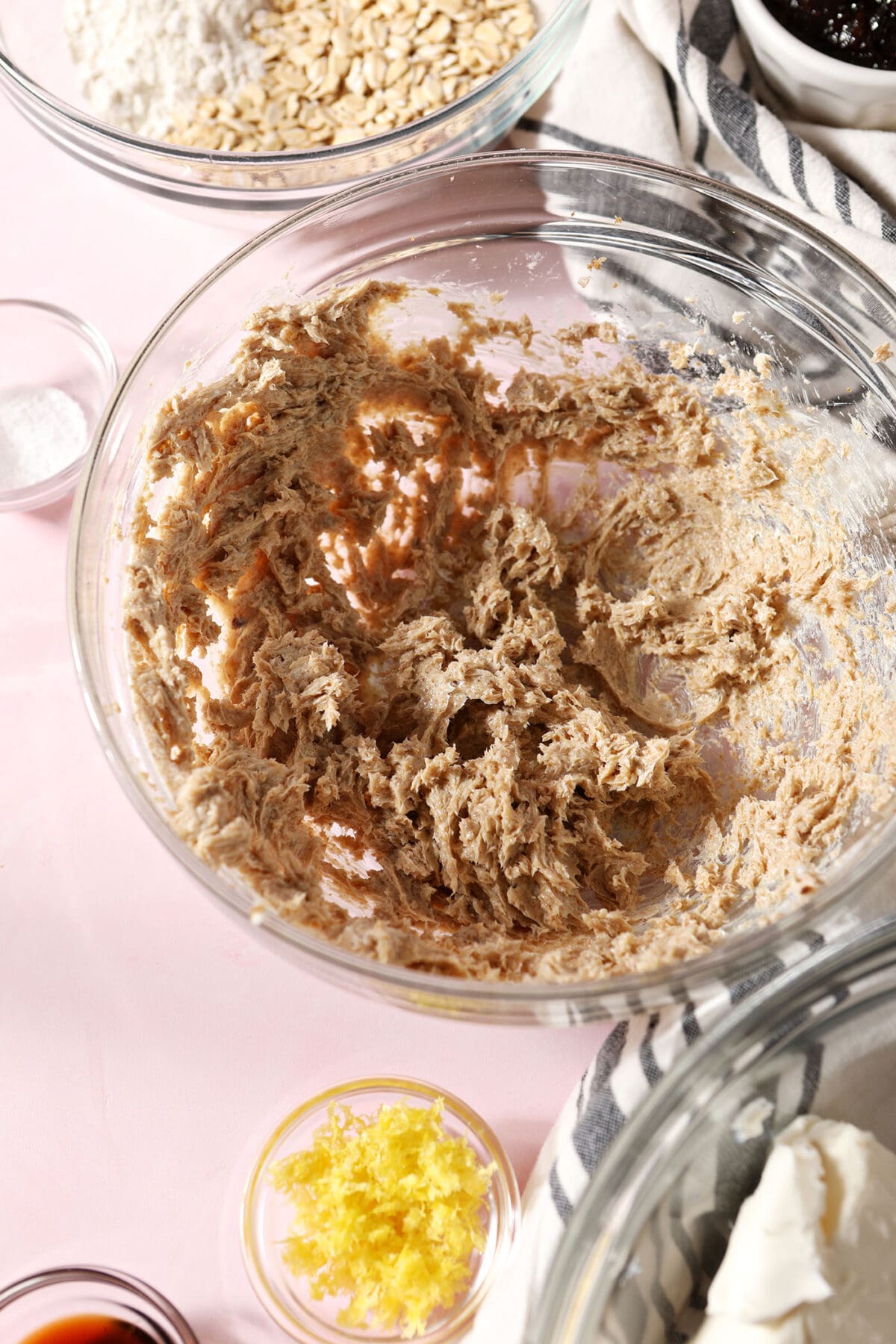 creamed brown sugar and butter in a bowl on a pink surface