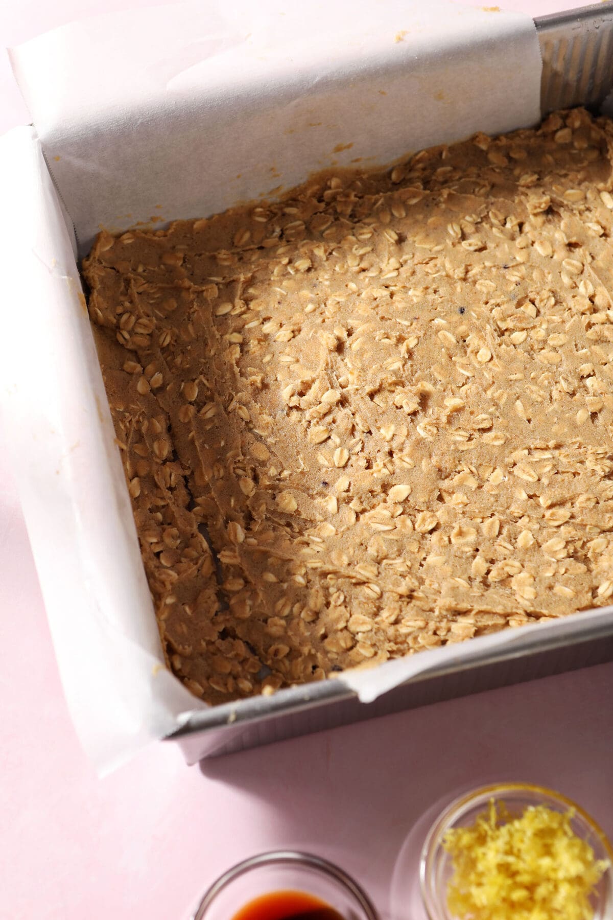 the pressed crust into a baking sheet on a pink surface before baking
