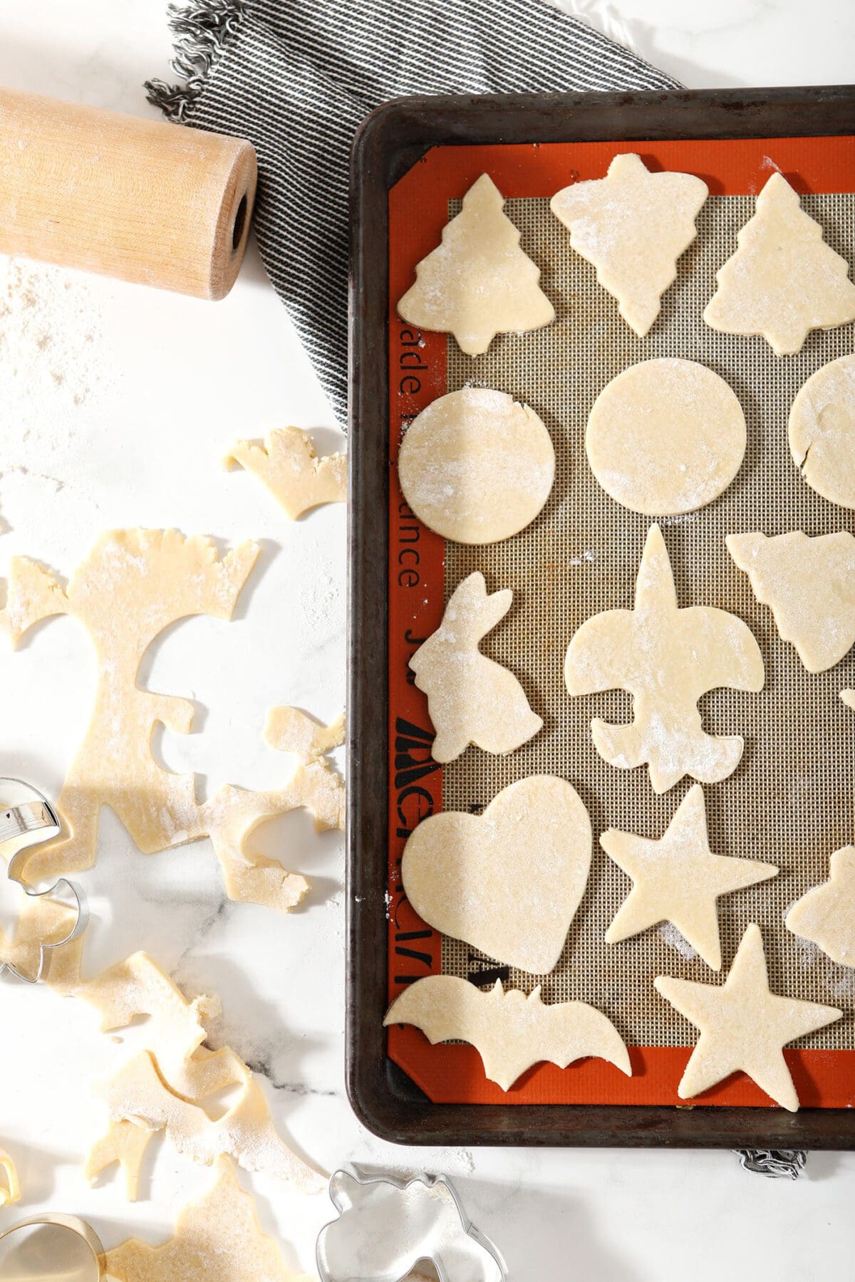 Cut out sugar cookies on a silicone-lined sheet pan before baking