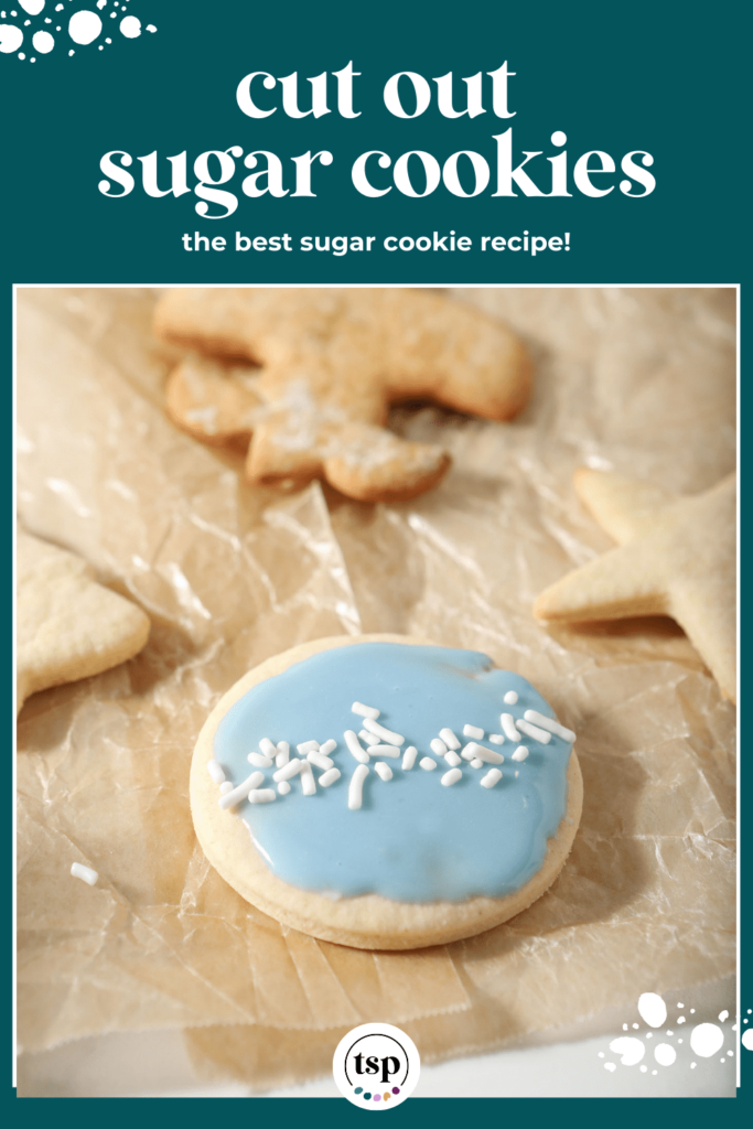 A single round iced sugar cookie on parchment with the text cut out sugar cookies the best sugar cookie recipe