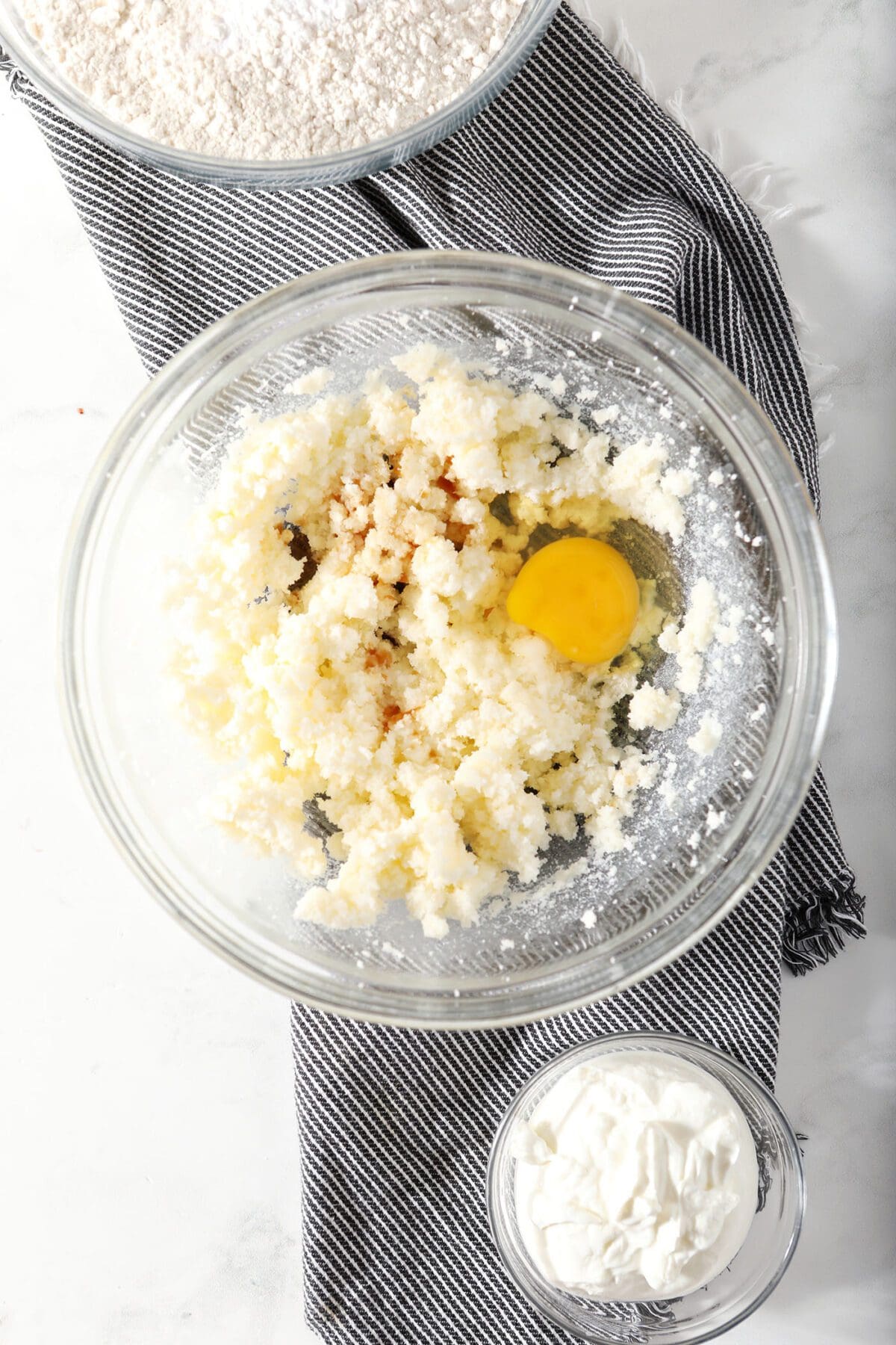 Egg and vanilla added to creamed butter-sugar in a bowl