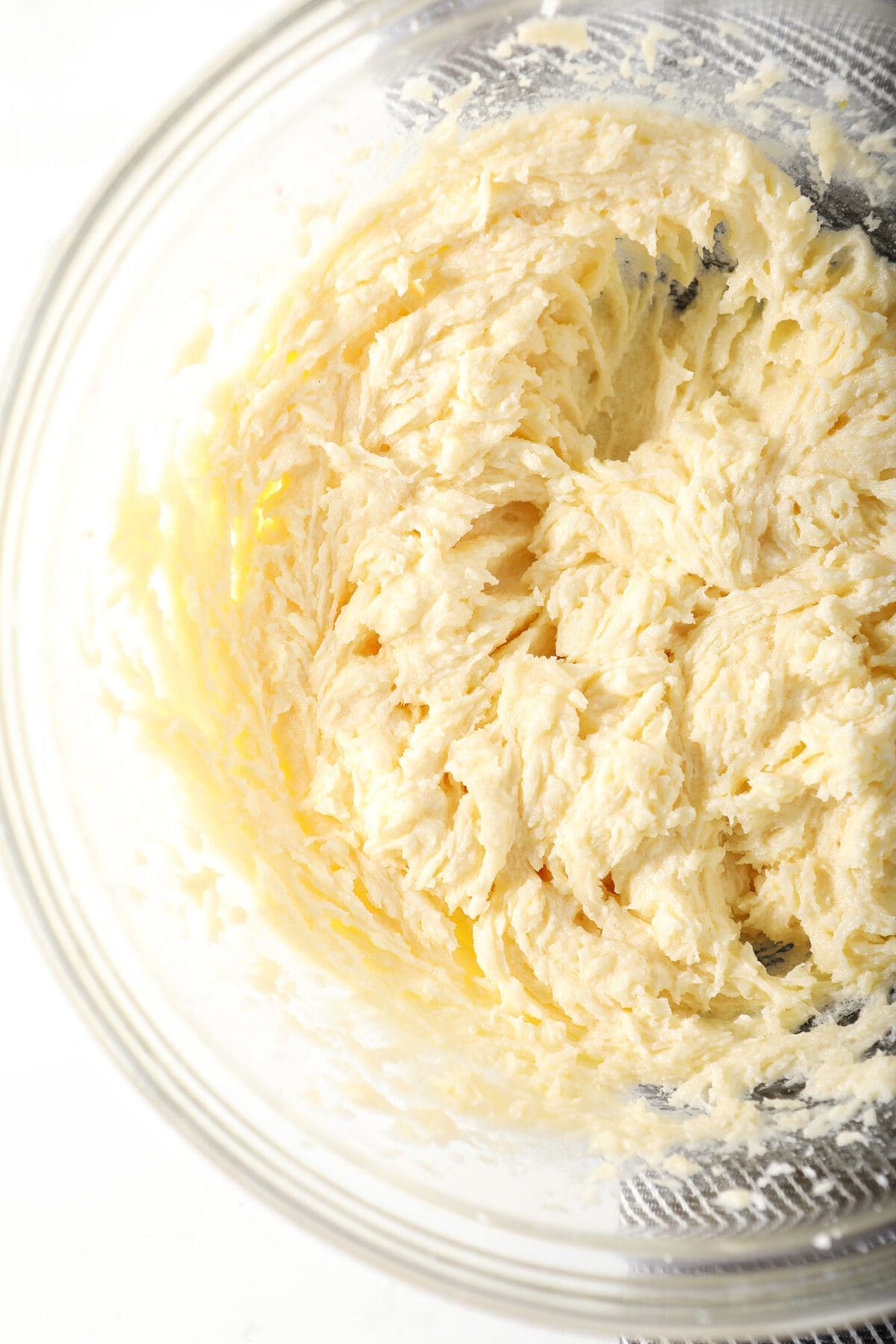 Close up of butter, sugar, vanilla and egg in a bowl after beating