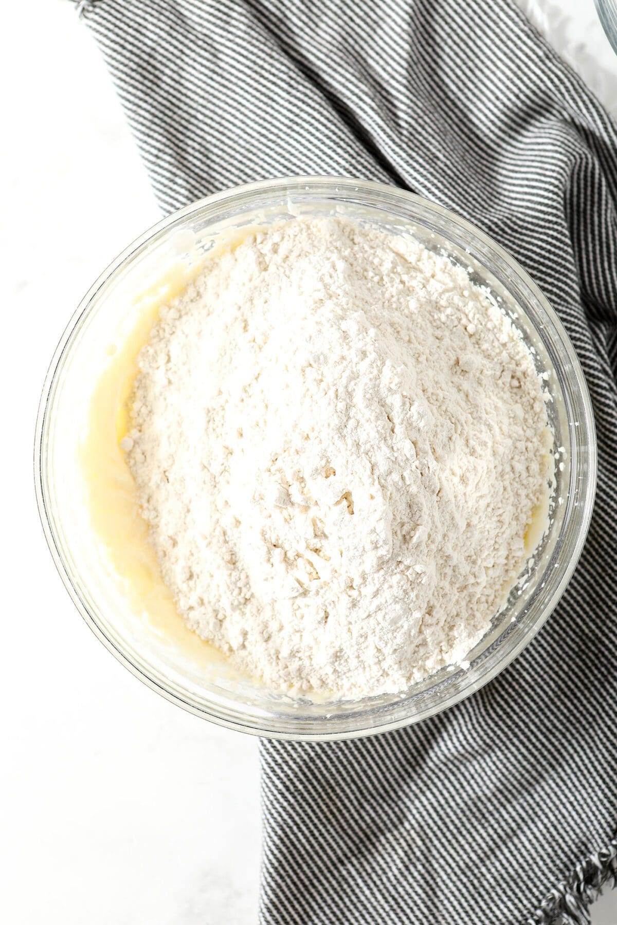 The flour mixture on top of the wet ingredients before blending to make the cookie dough