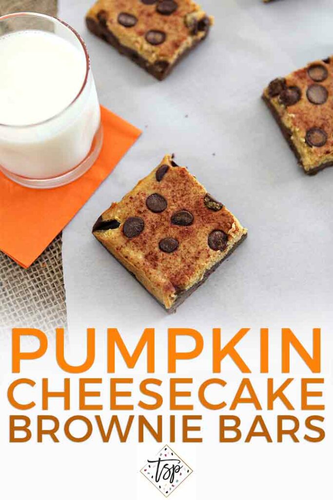 Overhead of pumpkin cheesecake bars on a white piece of parchment with a glass of milk and the text 'pumpkin cheesecake brownie bars'