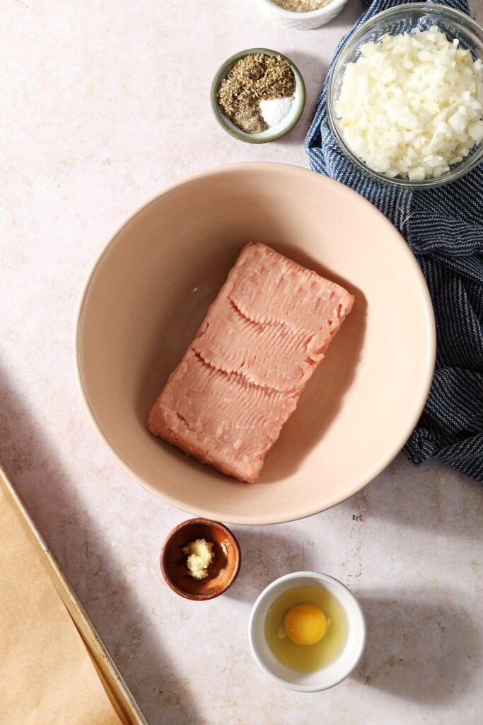 Ingredients to make turkey meatballs in bowls