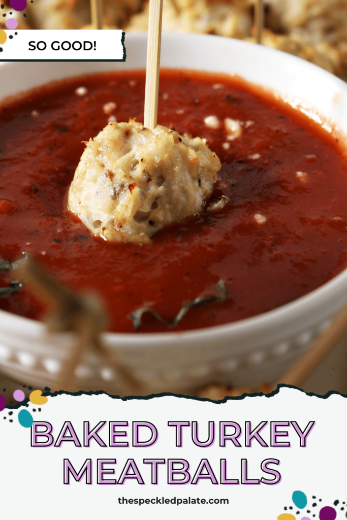 A meatballs dips into a bowl of marinara with the text baked turkey meatballs