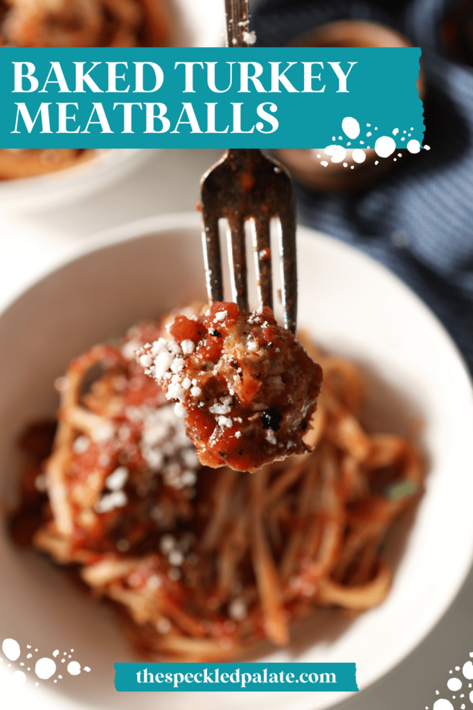 A fork spears a meatball over a bowl of pasta with the text baked turkey meatballs