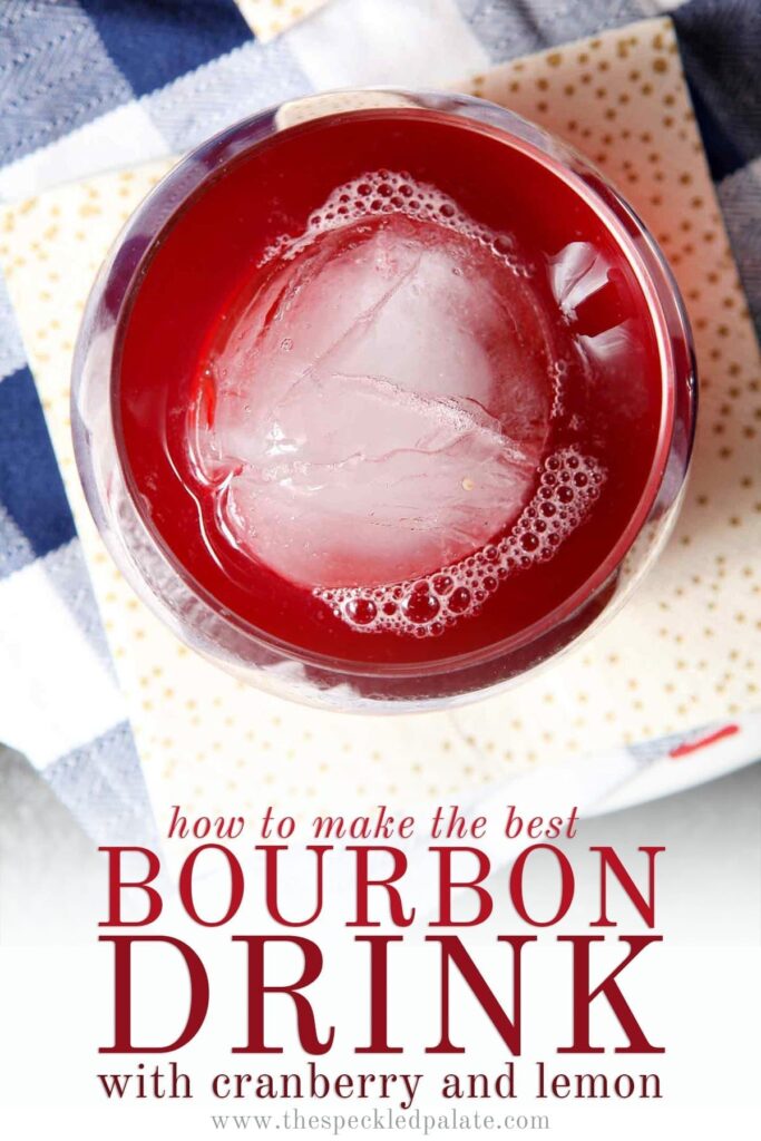 Close up of an old fashioned glass holding red liquid with the text 'how to make the best bourbon drink with cranberry and lemon'