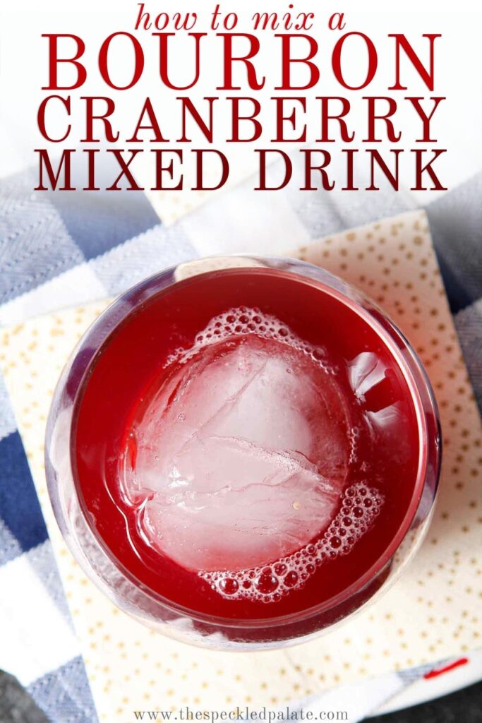 Close up of an old fashioned glass holding red liquid with the text 'how to mix a bourbon cranberry mixed drink'