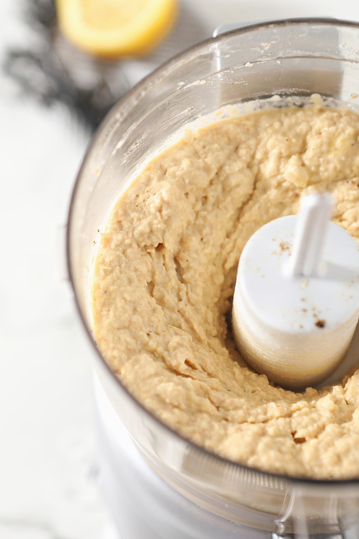 Close up of a food processor after hummus ingredients blended together