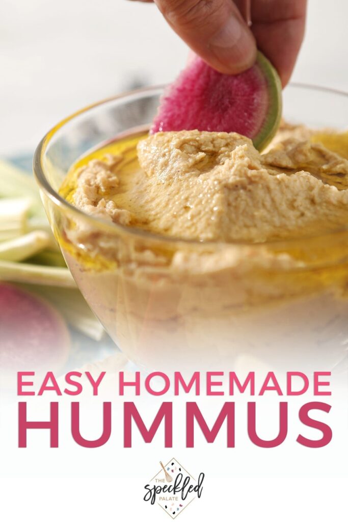 Close up of a woman dipping a watermelon radish slice in homemade hummus on a platter with text "Easy Homemade Hummus"