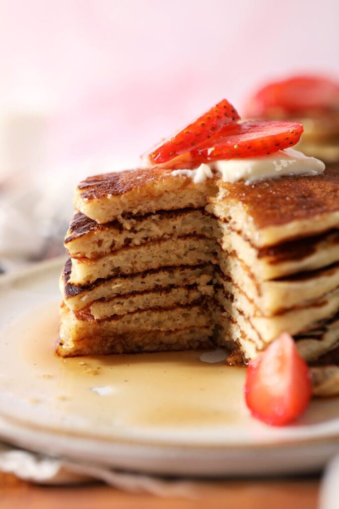 A close up of cut-into stack of oat pancakes