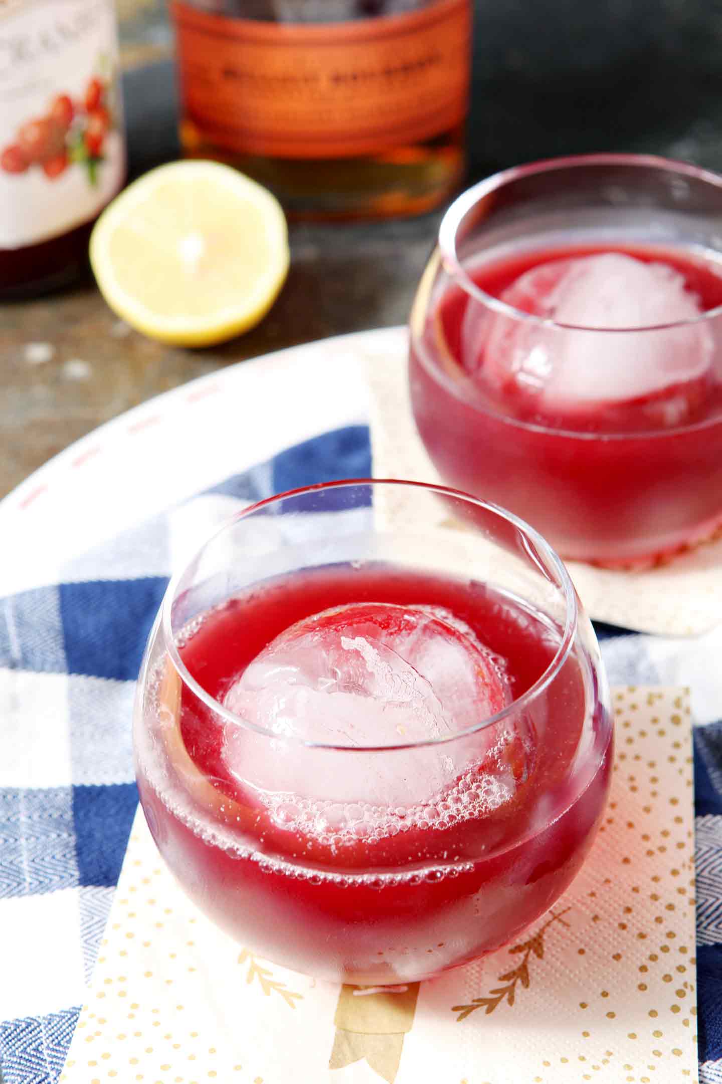 Two Blizzard (Bourbon Cranberry Cocktails) are served on a white platter