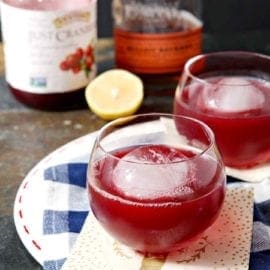 Two Blizzard Bourbon Cranberry Cocktails sit on a platter, ready for drinking