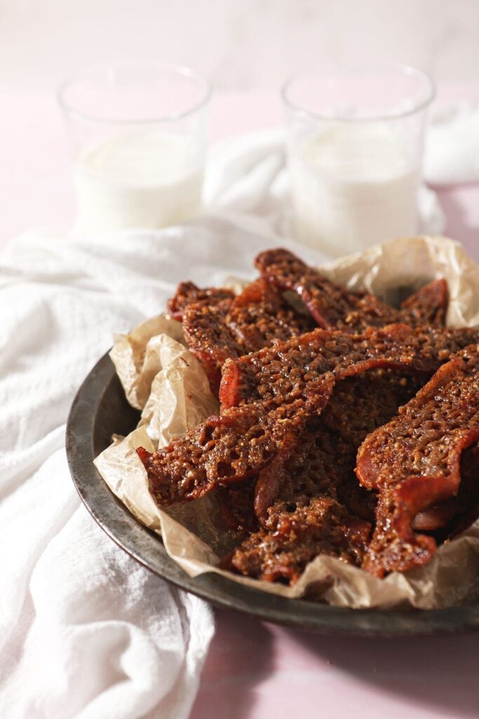 Praline Bacon sits in a metal serving container on top of a white kitchen towel