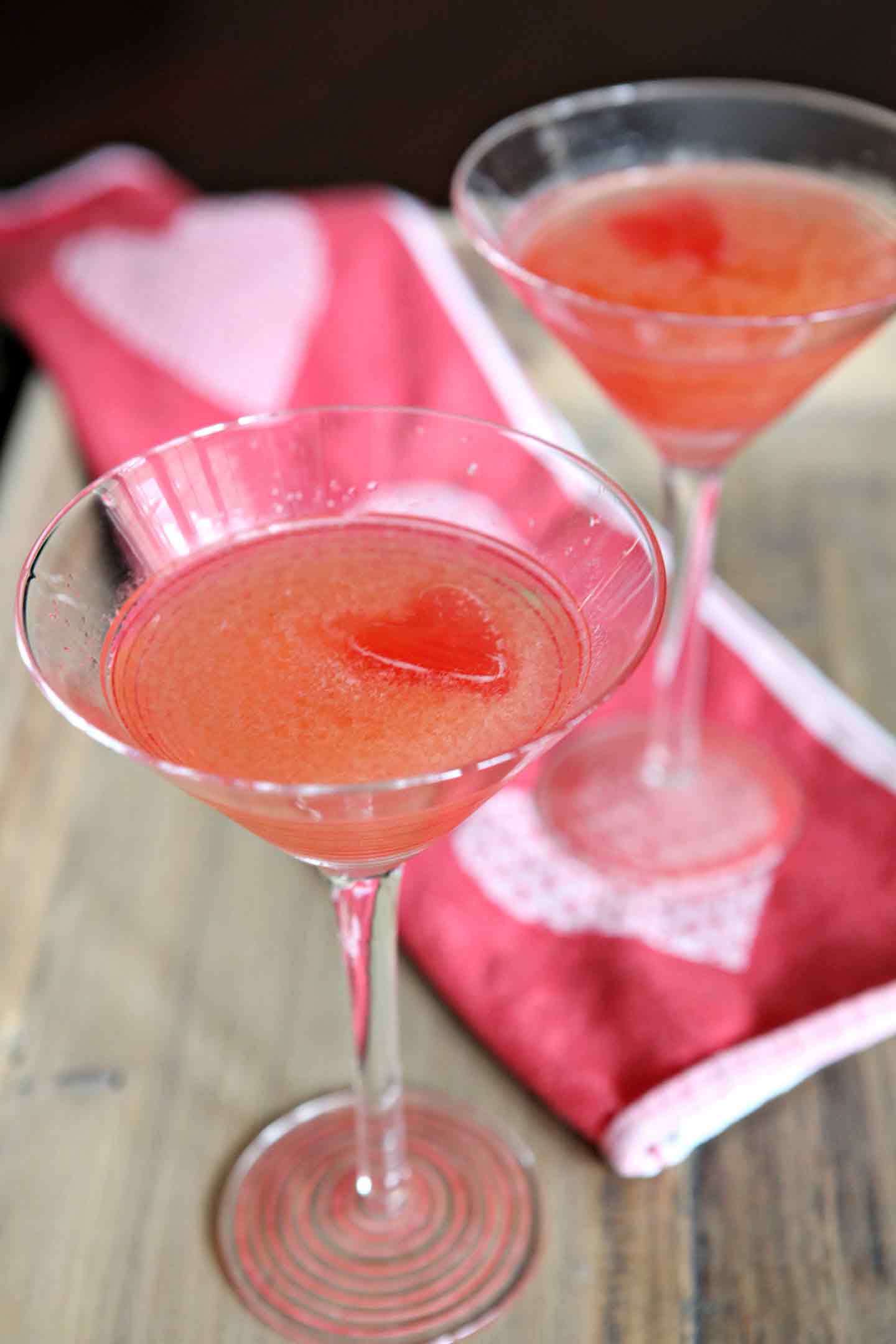 Angled close up of two drinks in cocktail glasses 