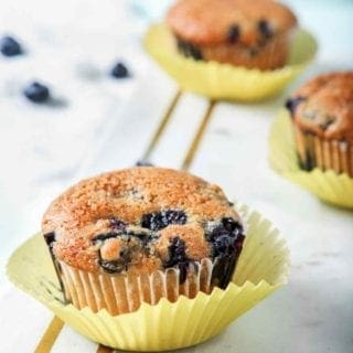 Vegan Blueberry Muffins, on a marble serving board, are displayed and ready to eat