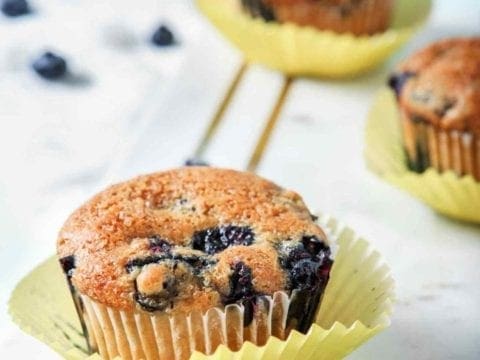 Vegan Blueberry Muffins, on a marble serving board, are displayed and ready to eat