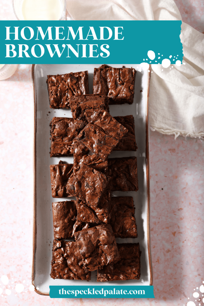 Sliced brownies on a rectangular plate with glasses of milk and a cream-colored linen with the text homemade brownies