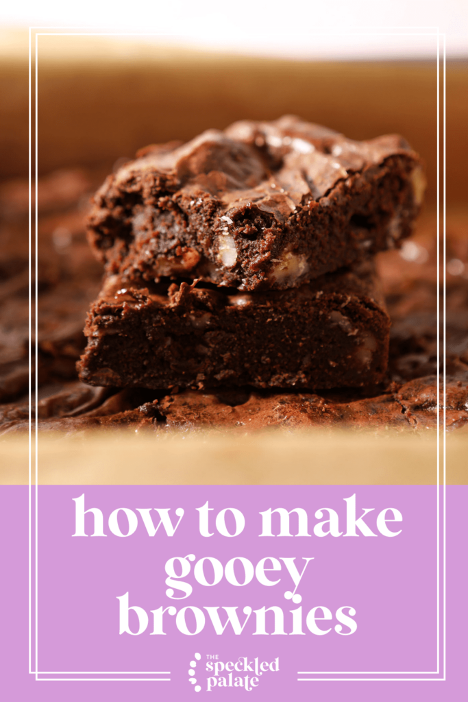 Two brownies stacked on top of each other in a baking dish with the text how to make gooey brownies